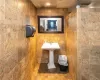 Bathroom featuring tile walls and tile patterned floors