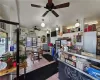 Kitchen with ceiling fan, an AC wall unit, and light tile patterned floors