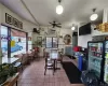 Dining space with ceiling fan, a wall mounted AC, tile patterned flooring, and a healthy amount of sunlight