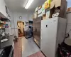 Kitchen featuring light tile patterned flooring, white fridge, and built in fridge