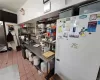 Kitchen with light tile patterned floors and refrigerator