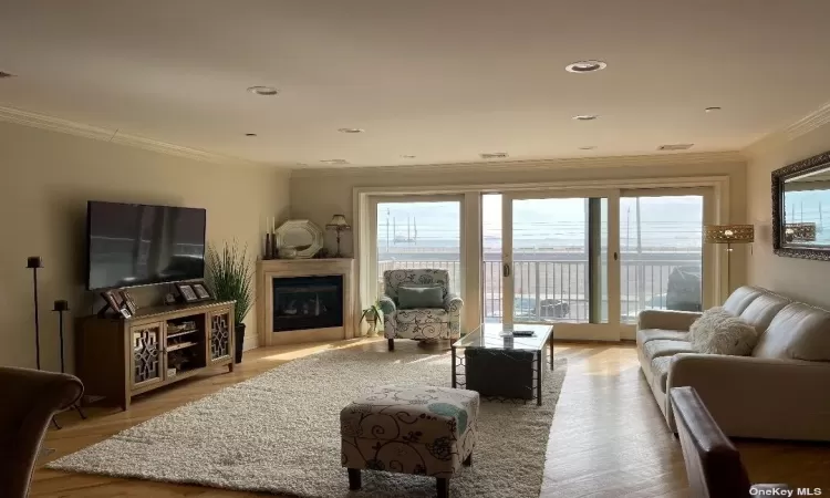 living room with gas fireplace, terrace & oceanviews