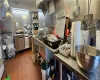 Kitchen featuring dark tile patterned flooring and stainless steel counters