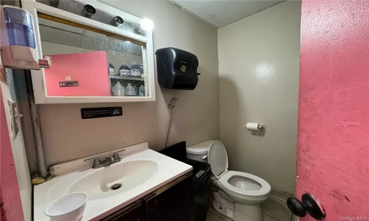 Bathroom featuring vanity, toilet, and tile patterned floors