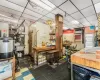 Miscellaneous room with a drop ceiling, sink, and a workshop area