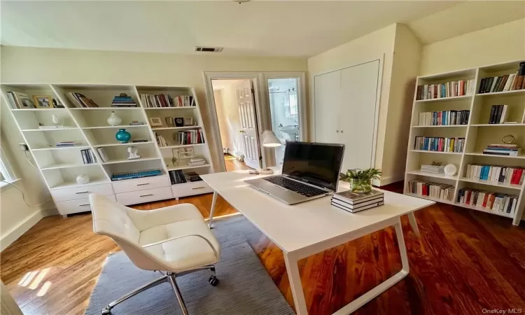 Virtually Staged - Upstairs center room staged as an Office with closet, light hardwood / wood-style flooring. Access to 2 bedrooms and a full bathroom are from this room.