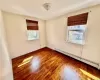 Upstairs - Bedroom 2 - featuring hardwood / wood-style flooring and a baseboard heating unit