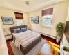 Virtually Staged - Upstairs Bedroom 2 featuring baseboard heating and dark hardwood / wood-style flooring