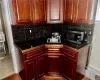 Lower Level - Kitchen with hardwood / wood-style flooring, tasteful backsplash, and sink