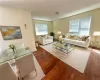 Virtually Staged - Living room with dark hardwood / wood-style flooring and a healthy amount of sunlight.