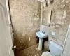 1st floor Half Bathroom featuring tile walls and toilet