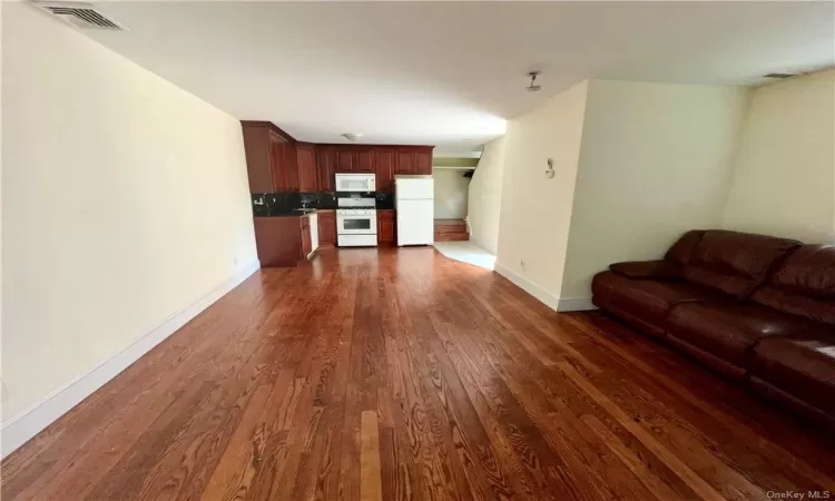 1st Floor - Unfurnished living room with dark hardwood / wood-style floors