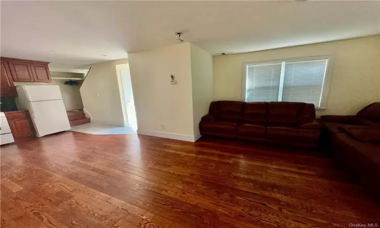 1st Floor - Living room with open concept kitchen  featuring hardwood / wood-style floors