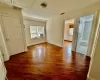 Unfurnished entry room to upstairs that can be used as a bedroom with closet, office or sitting room -  access to full bathroom with additional 2 bedrooms one on  each side, and wood-type flooring