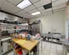 Kitchen featuring light tile patterned flooring, high end fridge, and a paneled ceiling