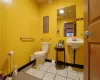 Bathroom with sink, toilet, and tile patterned floors