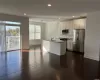 open concept kitchen with pantry and stainless steel appliances