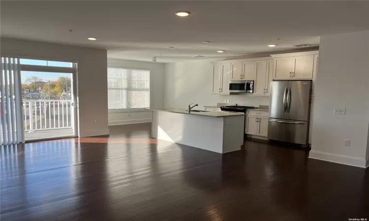 open concept kitchen with pantry and stainless steel appliances