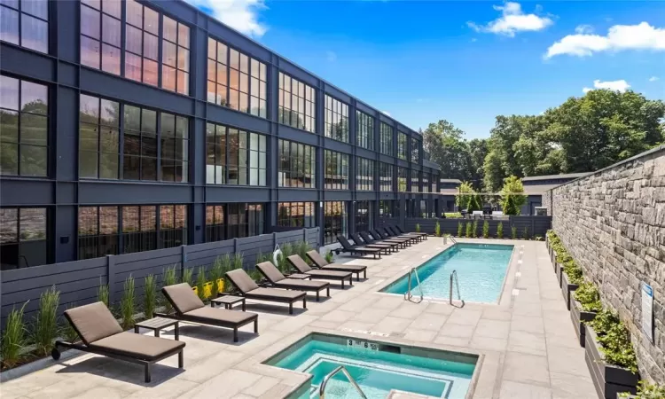 View of pool featuring a patio area and a community hot tub