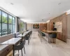 Kitchen with sink, pendant lighting, light hardwood / wood-style floors, a breakfast bar area, and wooden walls