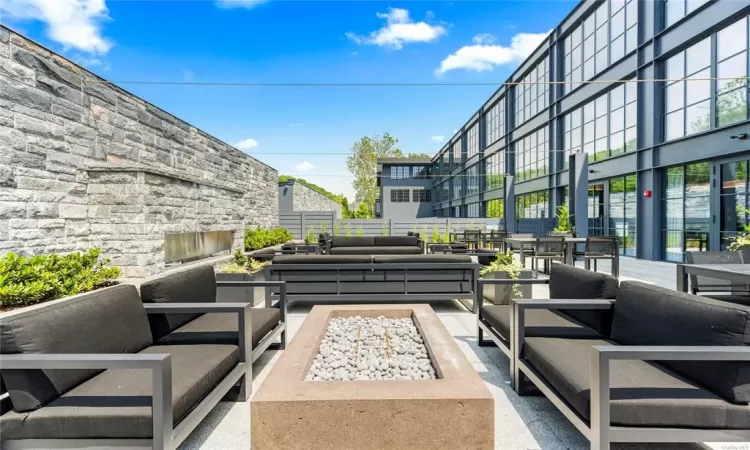 View of patio with an outdoor living space with a fire pit