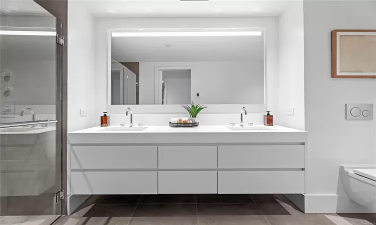 Bathroom featuring vanity, an enclosed shower, and toilet