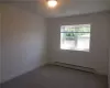 Carpeted empty room with baseboard heating