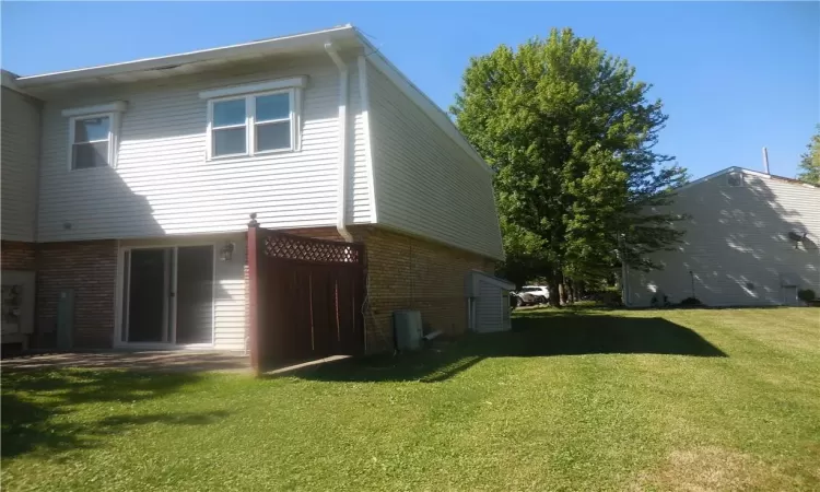 Rear view of property with a lawn