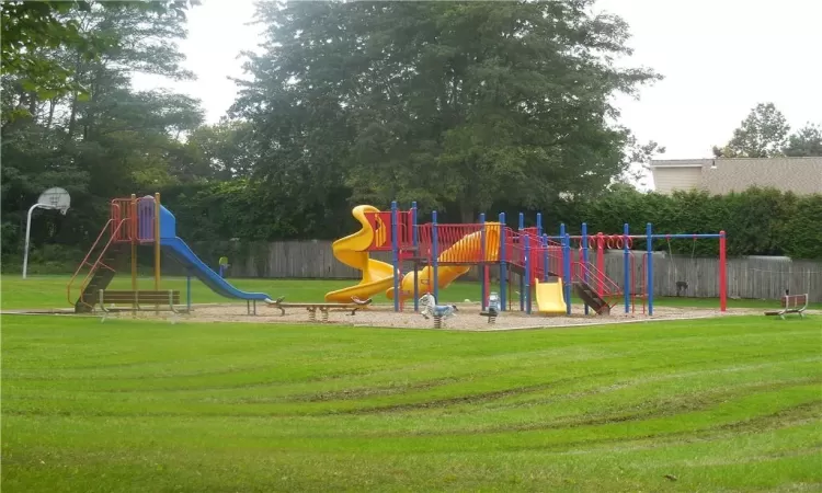 View of playground featuring a lawn