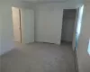 Unfurnished bedroom featuring carpet flooring and a closet