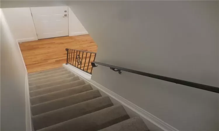 Stairway featuring wood-type flooring