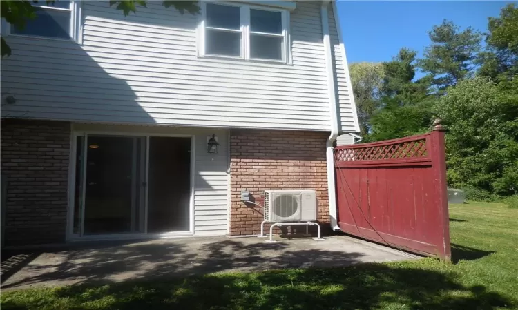 Rear view of house featuring a patio area and a yard