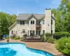 View of swimming pool featuring a patio and a wooden deck