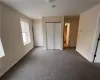 Unfurnished bedroom featuring a closet and carpet floors