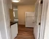 Kitchen featuring white fridge and dark hardwood / wood-style floors