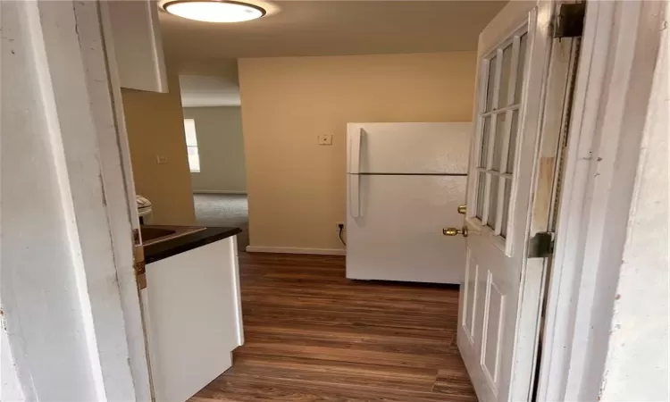 Kitchen featuring white fridge and dark hardwood / wood-style floors