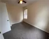 Empty room featuring carpet and ceiling fan