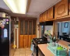 Kitchen with range, refrigerator, ventilation hood, and light tile patterned floors