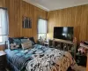 Bedroom with crown molding and wooden walls