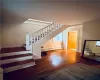 Stairs featuring baseboard heating and hardwood / wood-style floors