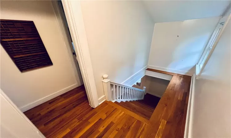 Stairs featuring hardwood / wood-style flooring