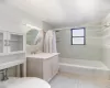 Full bathroom with vanity, tile patterned floors, toilet, and shower / bathtub combination with curtain