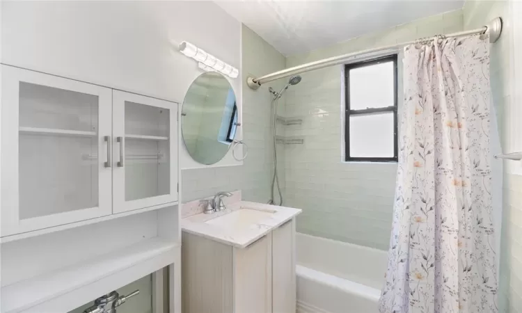 Bathroom with vanity and shower / bath combo