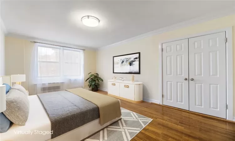 Bedroom with a closet and wood flooring