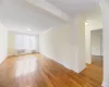 Unfurnished room with radiator, and wood flooring