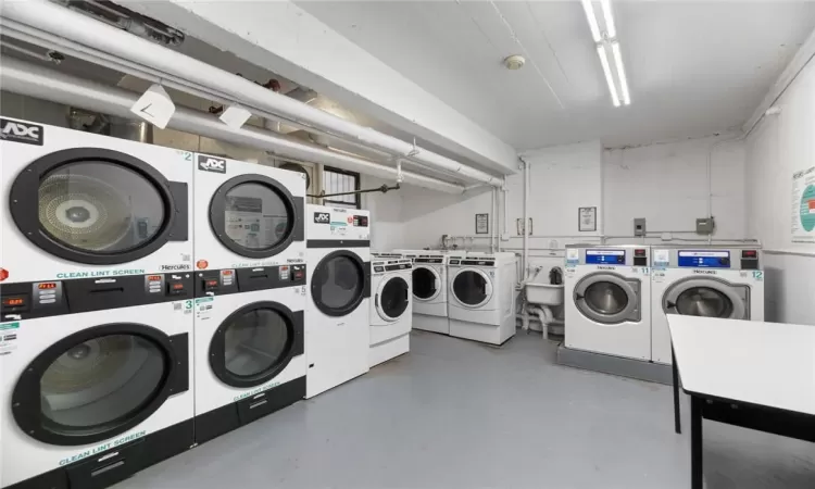 Laundry room with stacked washer / drying machine, sink, and independent washer and dryer