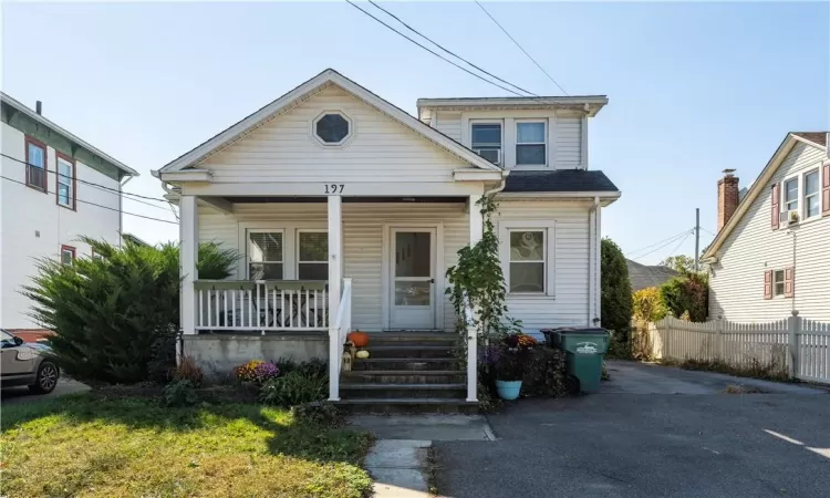 Cozy cottage style house with rocking chair front porch