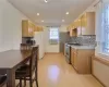 Kitchen with stainless steel appliances, radiator, plenty of natural light, and light hardwood / wood-style flooring