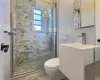 Bathroom featuring an enclosed shower and toilet