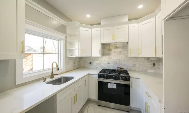 Spare room featuring sink, crown molding, and plenty of natural light